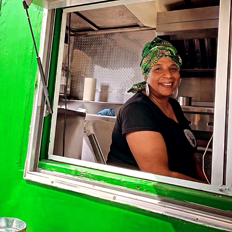 Chef Izolda Miranda smiling from the food truck window